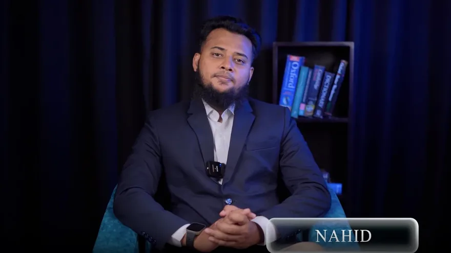 Najmul Nahid, seated, speaking to camera